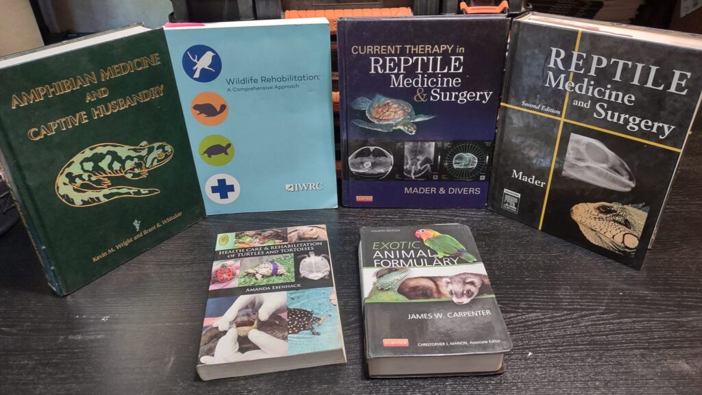 Six reference books on reptile, amphibian and turtle medicine and wildlife rehabilitation, including the IWRC's Wildlife Rehabilitation and the Exotic Animal Formulary. Photo by Micha Petty.